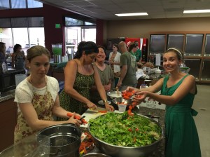 The food prep team preparing a mega-sized bowl of salad
